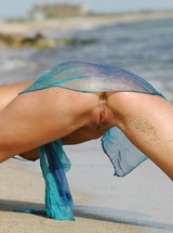 Playful girl Uma B gets wet and dirty on the beach