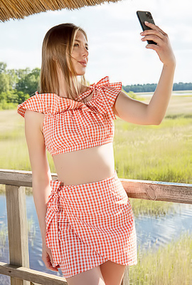 Karianne Bending Over The Railing With A Smile