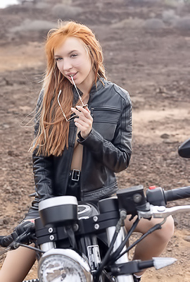 Lilly Mays Rides A Motorcycle In The Desert Wearing A Leather Jacket And Miniskirt