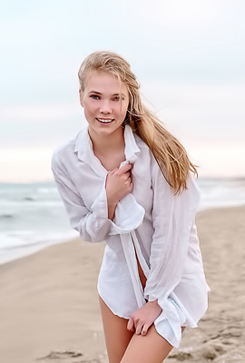 Luise Entices With A Beach Striptease Revealing Perky Nipples And Grabbing Her Curves