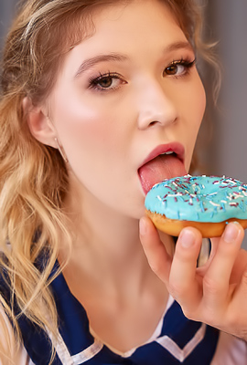 Mia Murkovski licks the cream off the donut while her boyfriend watches and joins